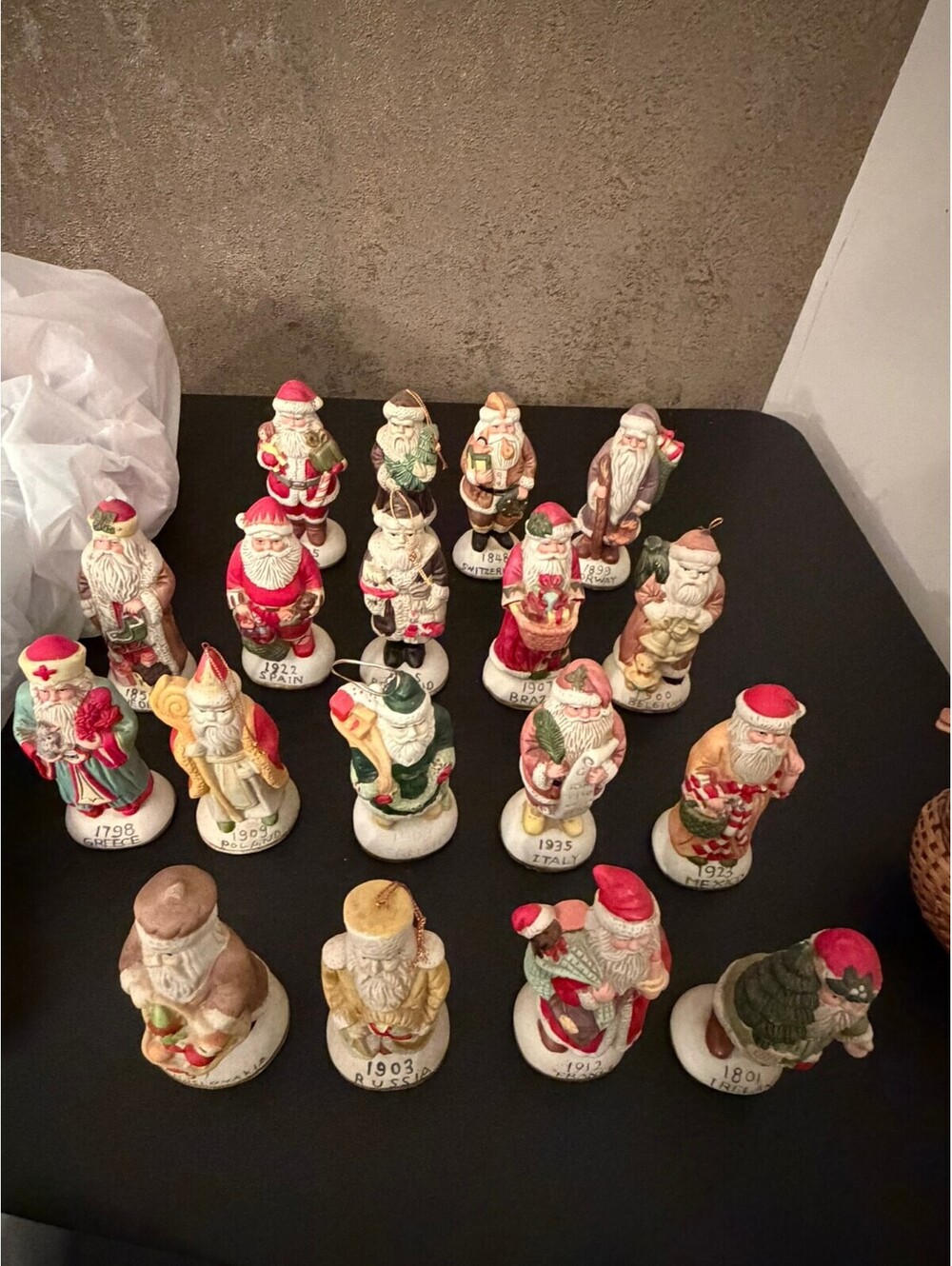 Vintage Santa Claus Figurine Collection Featuring Various Countries and Years